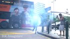 Hong Kong protester locating and dealing with a tear gas round, cameraman with the tracking shot