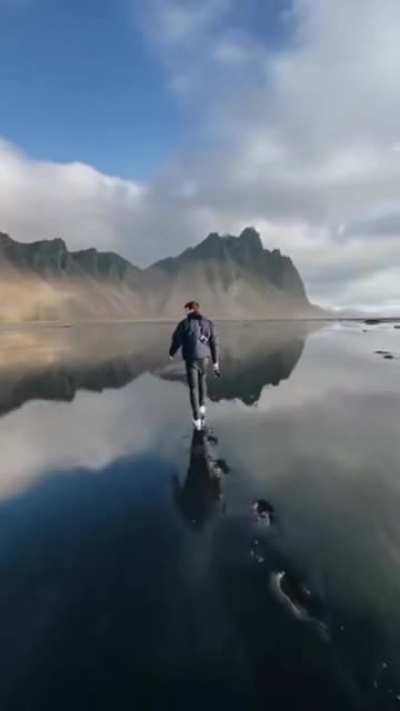 Man walking at a black sand beach Iceland