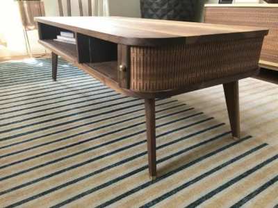 I designed and built a mid century style coffee table with a cnc kerf cut “tambour” door. It was also my first time having custom brass hardware made for the feet, which turned out nice.