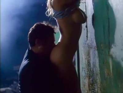 Pamela Anderson sex up against a wall in “Raw Justice”