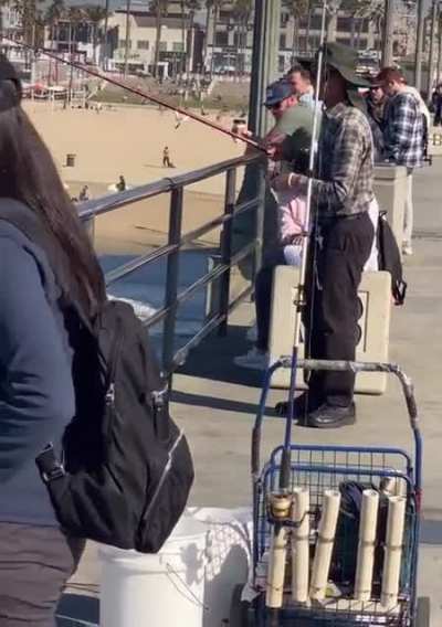 Surfing near a pier where it’s legal to fish. (Huntington Beach, CA.)
