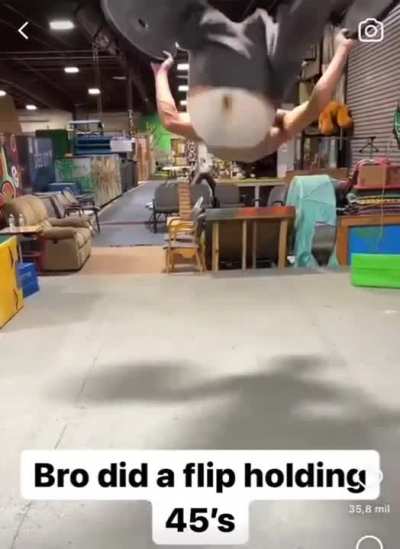 This guy did a flip while carrying two 45 pound weights 🤯