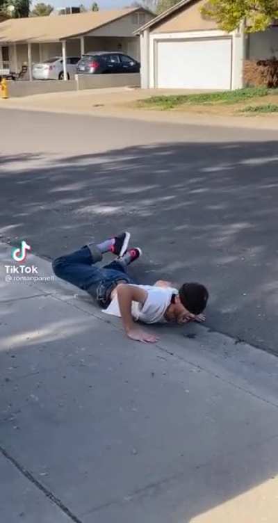 Guy aggressively high fives the ground after falling off his heelys