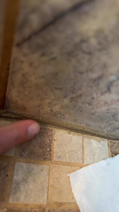 Water under tile around edges of shower