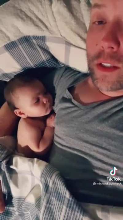 Dad singing to his baby girl. You can already see the live in her eyes as she is staring at him.