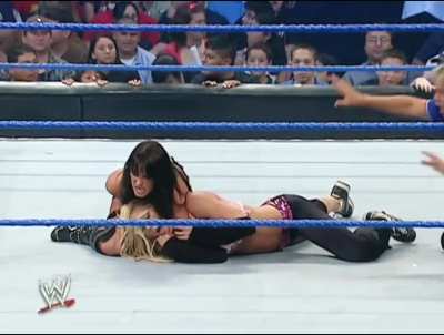 Victoria applies a long sleeperhold on Torrie Wilson as she talks shit to her. “Come on Princess!”