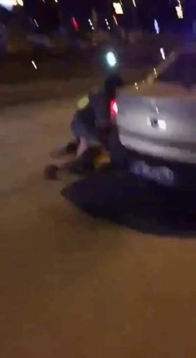 Crazed Russian jumps on a police car.