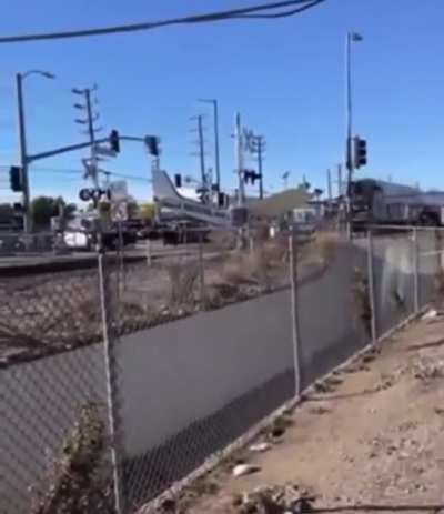Crashed plane becomes unexpected participant in a train crash (pilot was pulled to safety just in time)