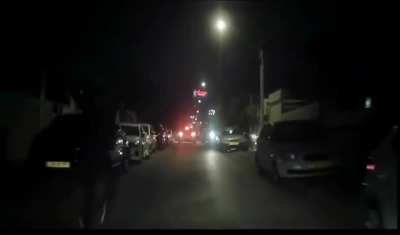 Palestinian rioters in the mixed city of Lod, Israel try to ambush Jewish people as they reverse from the blocked street and fire a warning shot