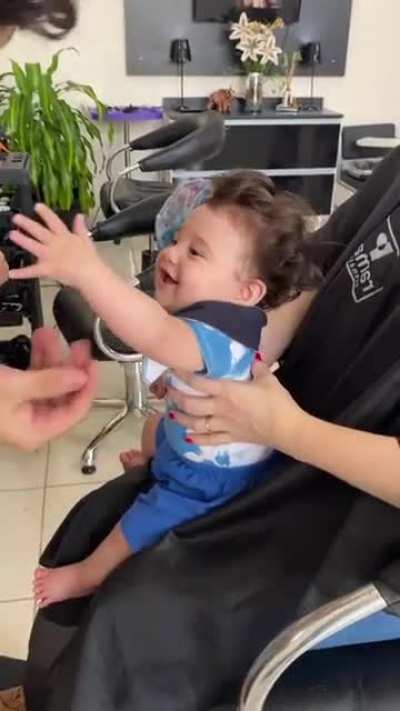 A 6 month old kid loving his first haircut