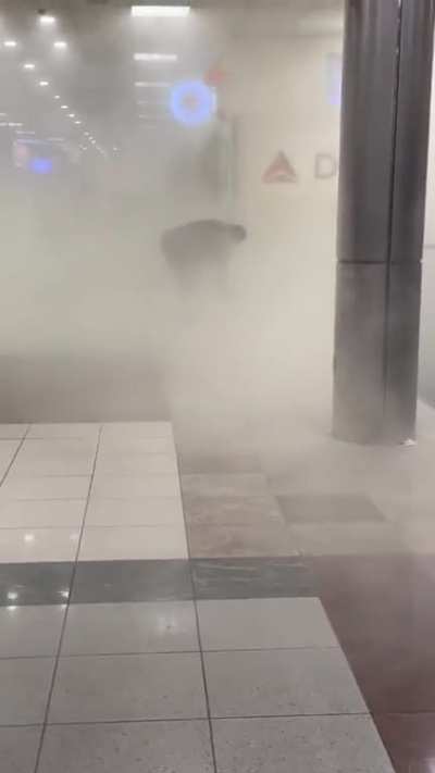 Crazy girl sprays fire extinguisher over the airport
