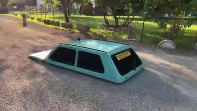 There's a guy inside driving this thing. He is laying down.