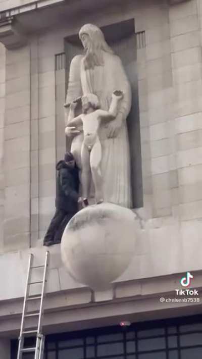 Guy climbs onto the BBC building and attempts to smash up the Eric Gill pedophile statue