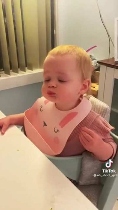 Baby's first bite of pizza
