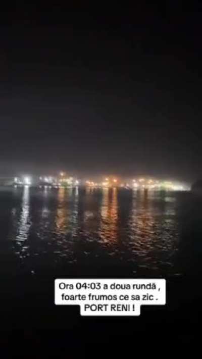 Russian Geran-2 drone flies through Ukrainian AA fire to hit target in Reni harbor, filmed by Romanians across the border