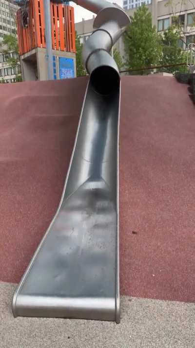 Policeman using a park slide...