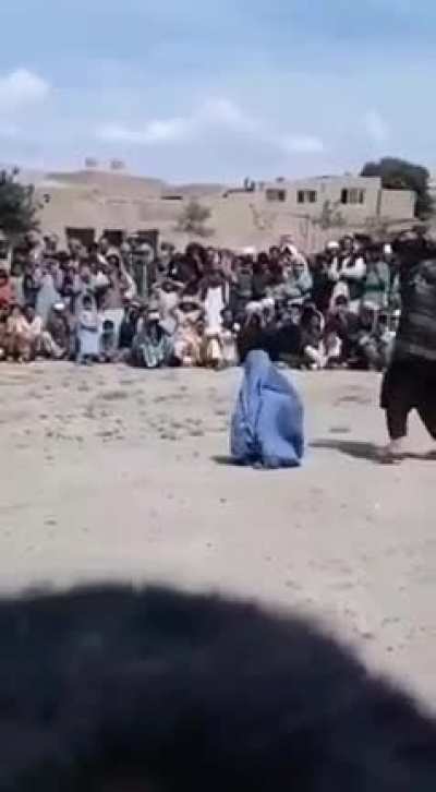 Woman being punished for being caught with a man before marriage somewhere in Afghanistan and the public enjoying the view.