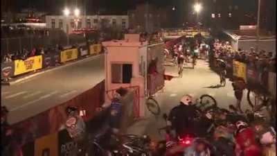 Standing in the middle of the road during a race.