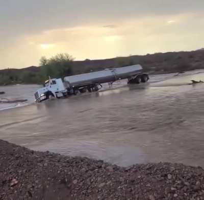 Semi-truck drives straight into flood waters
