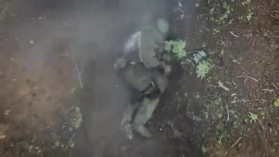 UA pov: Drone drops two grenades, one after the other on Russian soldier who manages to grab and throw them away before detonation.