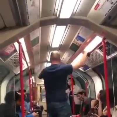 Young woman being threatened by drunk man on central line in London & bunch of guys come to the rescue