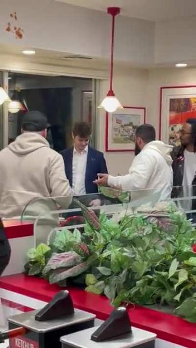 White Nationalist Nick Fuentes throws drink at person who threw ketchup at him.