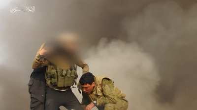 Hamas break through the separating barrier near Khan Yunis and targets a nearby tank, imprisoning the soldiers in it.