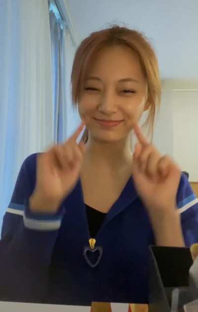 Tzuyu pokes her dimples and winks