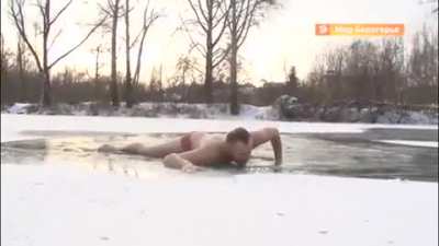 Russian journalist diving into the ice-cold water in the middle of the coldest day of the year to save a drowning stray.
