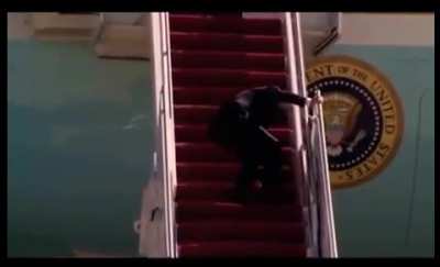 President Joe Biden falls up stairs while boarding Air Force One