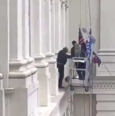 Replacing an American flag with a Trump flag...