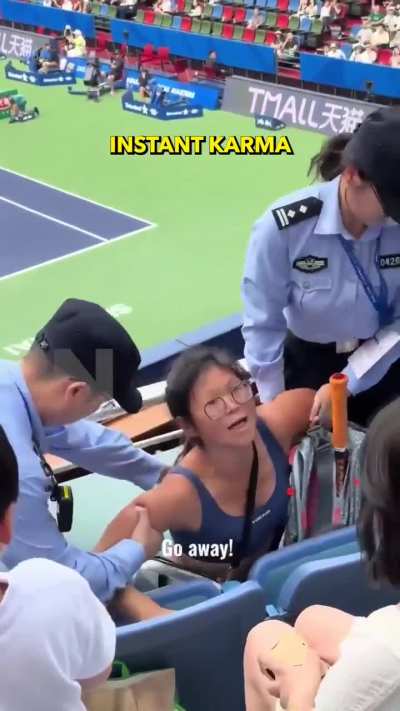 Woman disrupting a game and showing off her EU passport