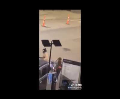 Guy on his motorbike shouting at a girl on the street, then rides away screaming.