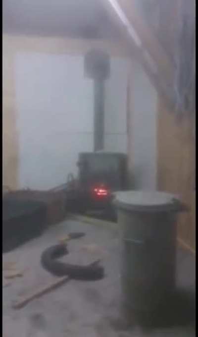 2 dudes putting a spray can in the oven