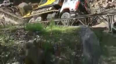 That guy walking behind the truck. Is there anyway the truck doesn't land on him?