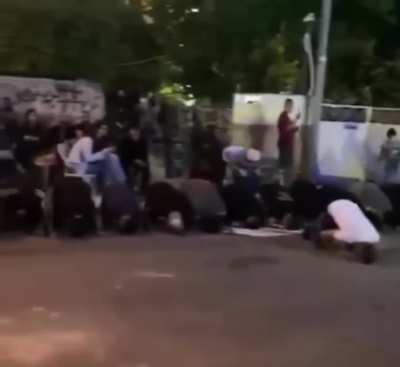 Palestinians praying for the people they have lost, israelis celebrate infront of them