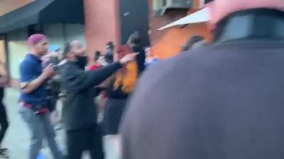 BLM protesters in Louisville confront a group of diners. One of the diners takes out a gun