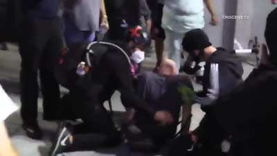 BLMers/anti-police protesters sucker punch man holding a dog multiple times, street 