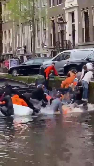 Celebrating King's Day on the canals in Amsterdam 