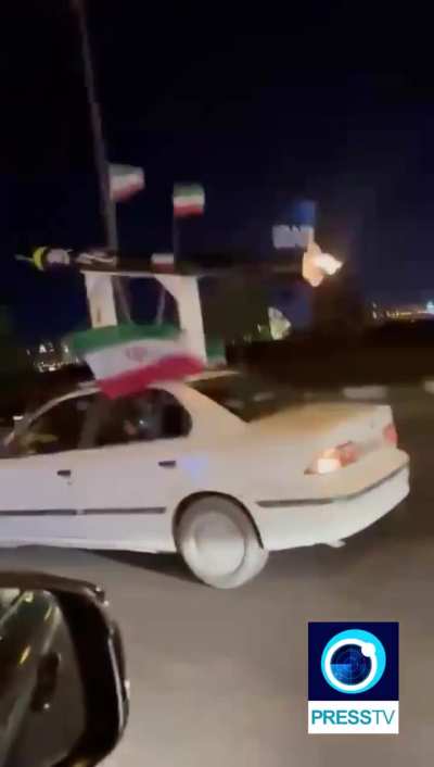 An Iranian patriot spotted driving around with an Iranian missile on top of his car