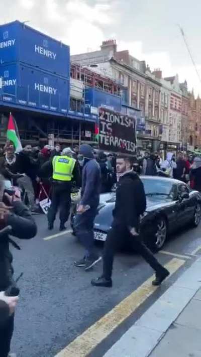 Pro-Palestinian protestors in the UK smash a car up