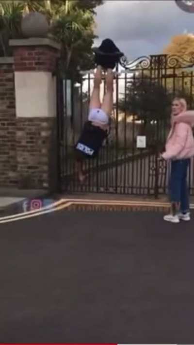 Cop poops💩 his tighty-whitey's as he struggles upside-down to free himself when pants are caught on fence. Onlookers point, laugh, and urge other bystanders not to help him down