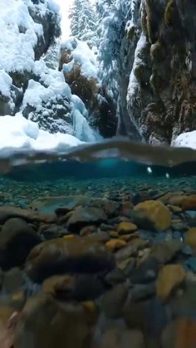 Snowflakes falling into crystal clear water