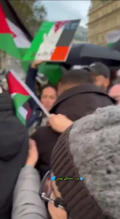Man holds up sign saying 