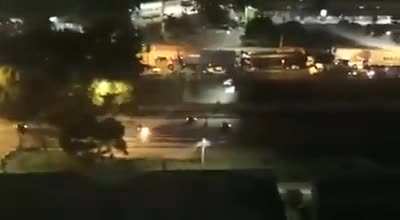 Molotov gets accurately thrown to a moving Policeman by a protestor.