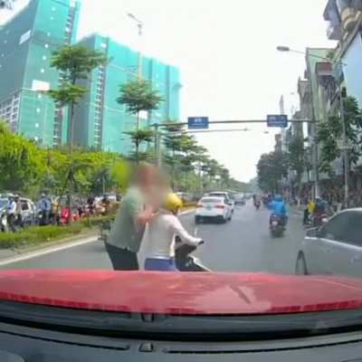 Asian woman stops in the middle of traffic using her phone