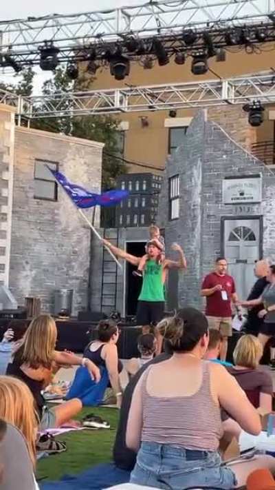 Trump supporter tries to photograph son waiving flag. Then tries to be cool and gets boo’d.