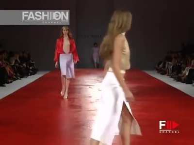 Model tries (unsuccessfully) to contain her breasts