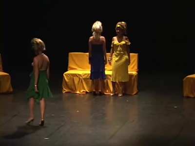 Four women compete for a necklace by exposing their breasts