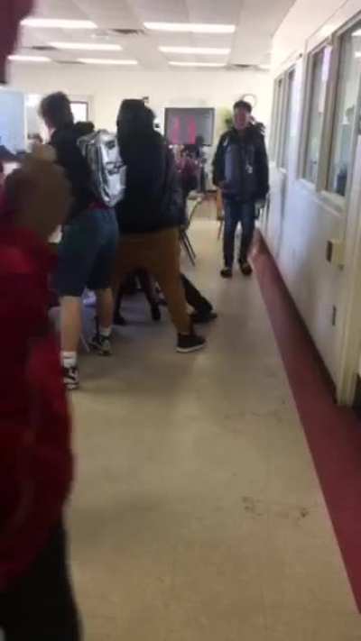 Guy gets hit with a textbook. Fight in school.